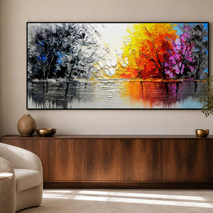 Black-framed lake painting with contrasting autumn foliage above a walnut study cabinet.