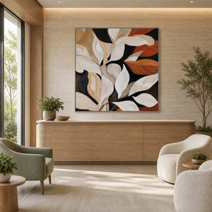 Silver framed botanical painting with cream leaves above a wellness reception counter.