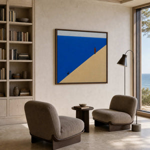 Quiet coastal wall art styled in a seaside reading lounge.
