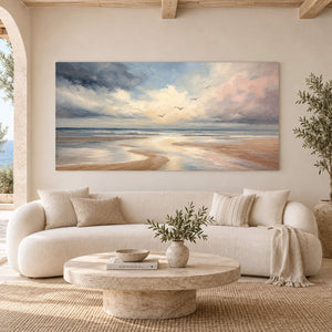 Hand-painted coastal wall art with pale blue, blush, and ivory shoreline, displayed in a living room without an outer frame.