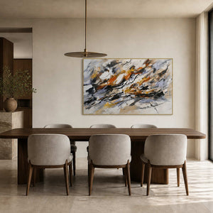 Textured black and ochre abstract art displayed in a contemporary dining room.