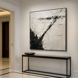 Expressive abstract wall art in an elegant entryway with a black frame.