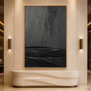 Dark textured abstract artwork displayed in a refined hotel lobby.