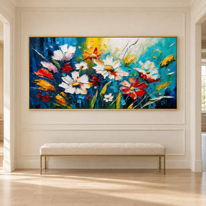 Hand-painted panoramic floral wall art in cobalt, turquoise, white, red, and yellow, displayed in a hallway in a gold frame.