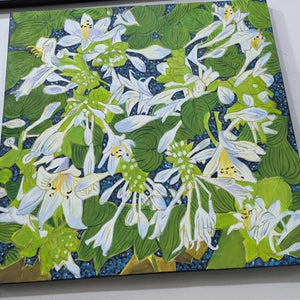 Angled close view of white flowers, curled petals and overlapping green leaves.