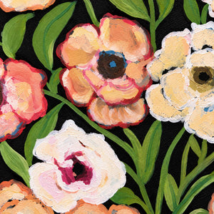 Close-up of cream and peach flower heads, dark centers and long green leaves on black.