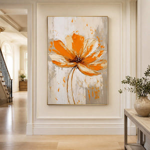 Gold framed orange floral artwork in a bright hallway beside a pale stone console.