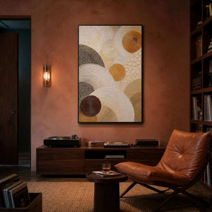 Layered circles in gold, brown, and ivory wall art in a contemporary home office.