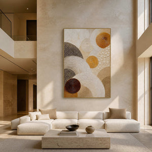 Layered circles in gold, brown, and ivory wall art in a contemporary living room.