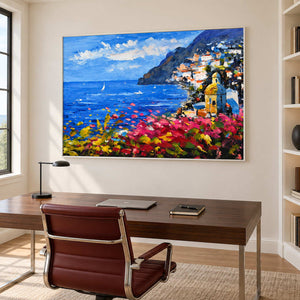 Bay and flowers artwork above a dark desk and red-brown chair.