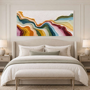 White-framed flowing abstract above a neutral bed with a muted green throw.