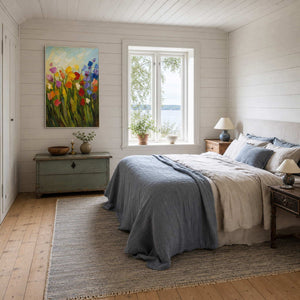 Textured floral wall art displayed in a serene white coastal bedroom.