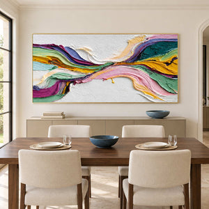 Wide flowing artwork behind a wooden dining table and cream chairs.