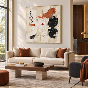 Dancing on a Whim in a gold frame above a cream sofa with rust cushions in a commercial lobby.