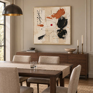 Dancing on a Whim in a gold frame above a wood sideboard behind a neutral upholstered dining set.
