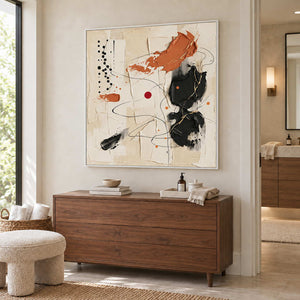 Dancing on a Whim in a white frame above a wood cabinet with folded towels and a soap dispenser.