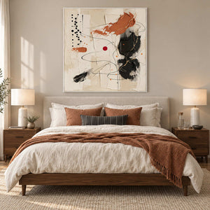 Dancing on a Whim in a white frame above a neutral bed with rust cushions and a warm brown throw.