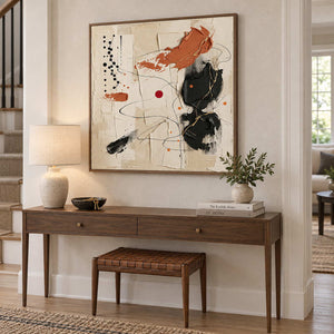 Dancing on a Whim in a wood frame above a hallway console and woven leather stool.