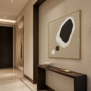 Dark Stone Held in White in a gold-framed entryway