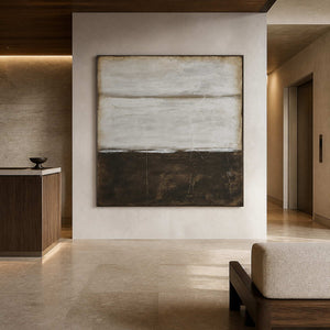 Wood-framed neutral abstract near a hotel reception counter and elevator corridor.