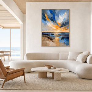 Blue and ochre seascape above a bright coastal modern living room.