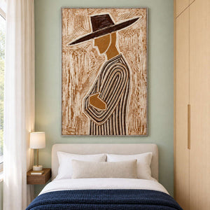 Tall profile artwork above a cream bed with navy throw on a pale green wall.