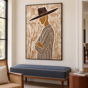 Left-facing figure artwork above a navy bench near a window and small side table.