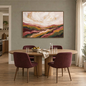 Dreaming of the Hills in a wood frame above an oval dining table with burgundy upholstered chairs.