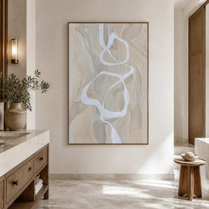 Wood framed pale abstract artwork beside a stone vanity in a spacious bathroom dry area.
