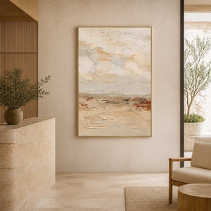 Gold framed pale landscape painting beside a stone counter in a spa reception.