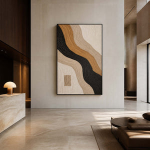 Vertical textured abstract wall art in an upscale hotel lobby with a black frame.