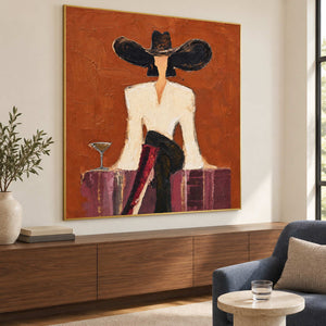 Angled view of the orange portrait above a long wooden cabinet.
