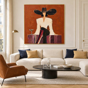 Orange figurative painting above a cream sofa with navy cushions.