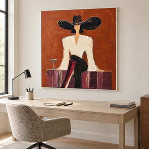 Seated-figure painting above a light desk beside a tall window.