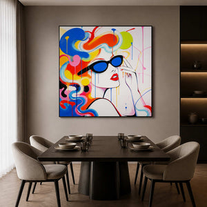 Colorful pop art portrait wall art in a dining room with a black frame.