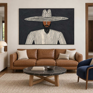 Cream and charcoal portrait above a brown sofa with a dark round coffee table.