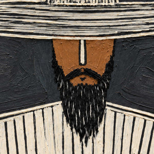 Close-up of looping cream hat lines, a warm brown face, and a textured black beard.