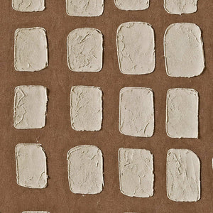 Close view of cracked cream rectangles with rounded corners on a fine brown ground.
