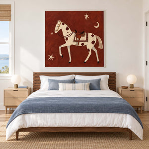 Rust-red equestrian painting above a wooden bed with blue bedding.