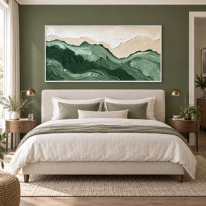 Free to Wander in a white frame above a cream bed with sage textiles against a deep olive wall.