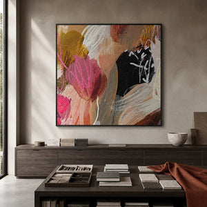 Colorful square painting in a black frame above architectural materials and fabric samples.