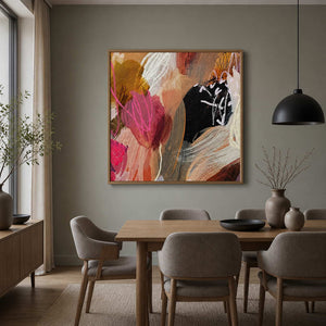 Wood framed colorful abstract painting displayed above a dining table and upholstered chairs.