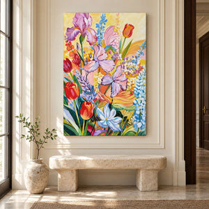 In an entryway above a console or bench, an artwork with no outer frame shows purple flowers, red cup-shaped blooms and blue-white sprays on yellow.
