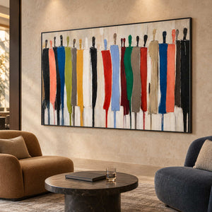 Horizontal figurative painting above a round coffee table between ochre and navy lounge chairs.