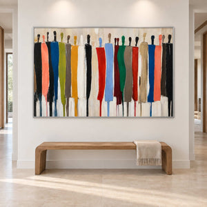 Wide abstract figure artwork above a simple wood bench in a bright entryway.