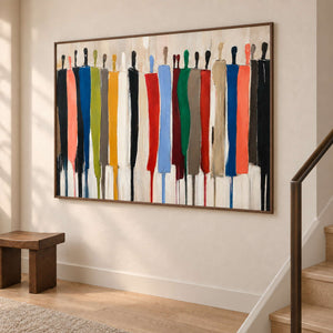 Angled view of the colorful figure painting beside a staircase and small wood bench.