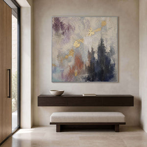 Gray and gold textured abstract wall art in a bright entryway.