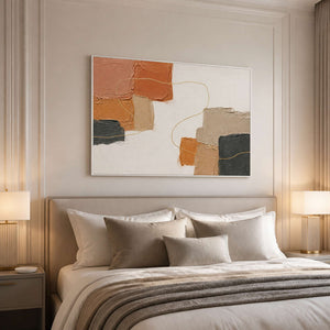 Terracotta and charcoal wall art styled above a calm neutral bed.