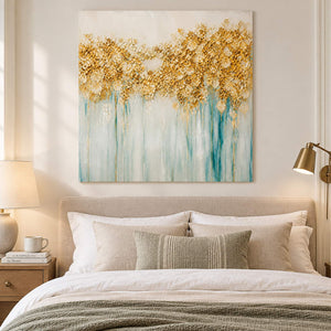 Hand-painted gold blossoms above soft aqua and ivory drips on canvas, displayed in a bedroom without an outer frame.