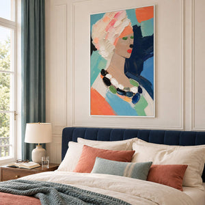 Colorful portrait painting of a woman with textured pale hair and a beaded necklace in a white frame in a bedroom.